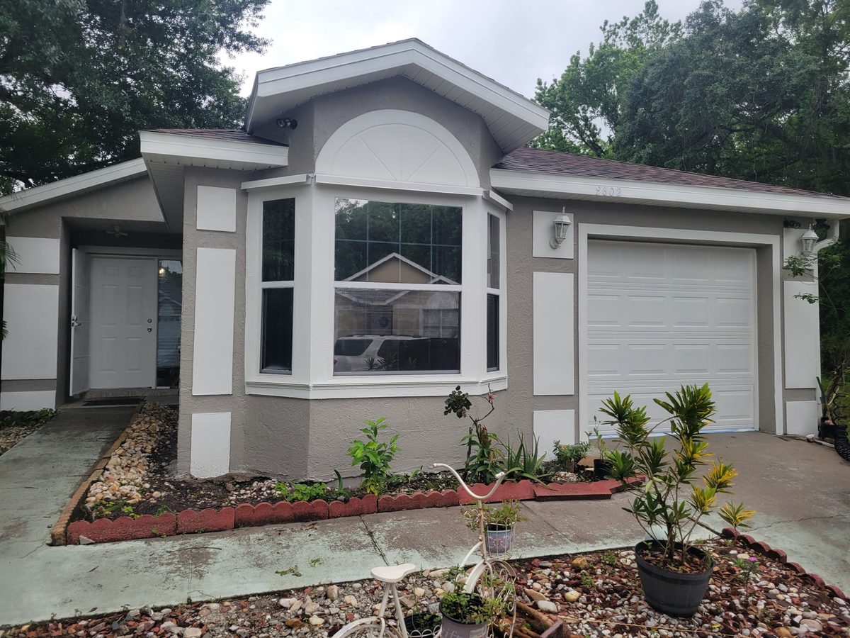 Freshly painted modern grey house exterior after professional repaint